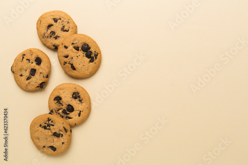 Flat lay with chocolate chip cookies on color background