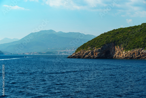 seascapes  a view of the rocks and a sea cave on the Bay of Kotor during a cruise on a ship in Montenegro  a bright sunny day  the concept of a summer trip