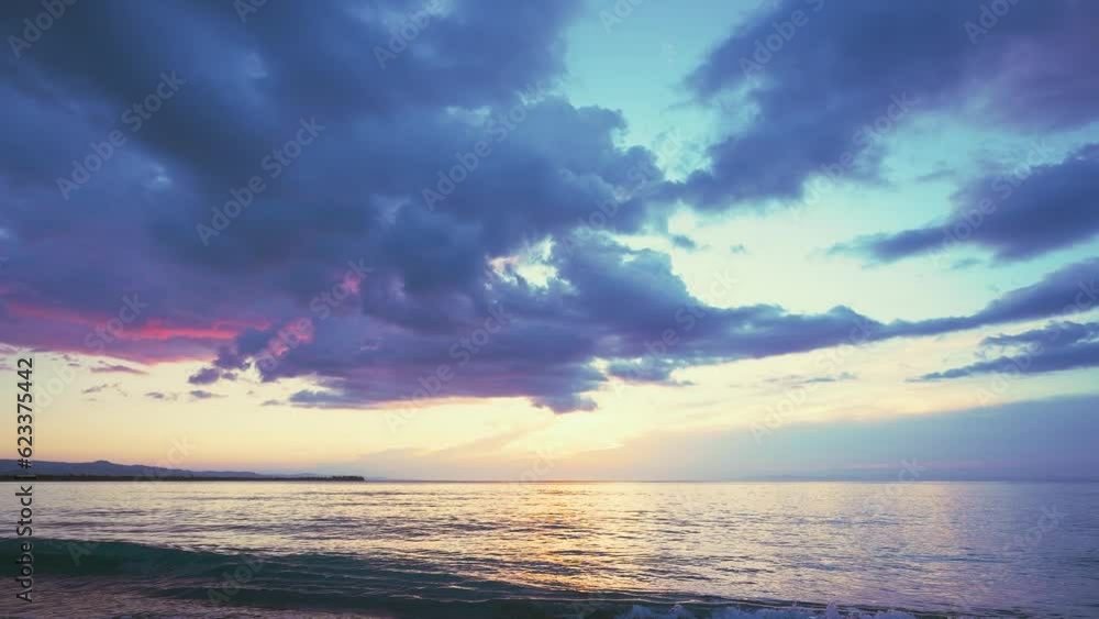 Picturesque landscape of the evening tropical coastline against the sunset sky. Exotic sunny beach with turquoise sea waves on a Caribbean island. Summer holidays and paradise beach concept. Picturesque landscape of the evening tropical coastline against the sunset sky. Exotic sunny beach with turquoise sea waves on a Caribbean island. Summer holidays and paradise beach concept.
