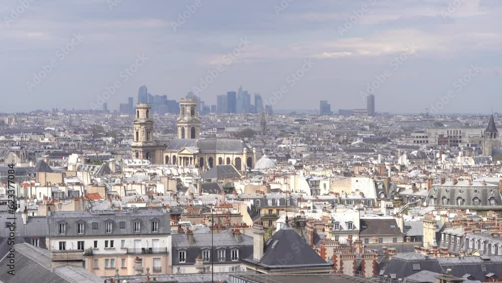 Church of Saint-Sulpice, a Roman Catholic Church Raising from Paris Skyline, Defense Business District in the Background Church of Saint-Sulpice, a Roman Catholic Church Raising from Paris Skyline, Defense Business District in the Background