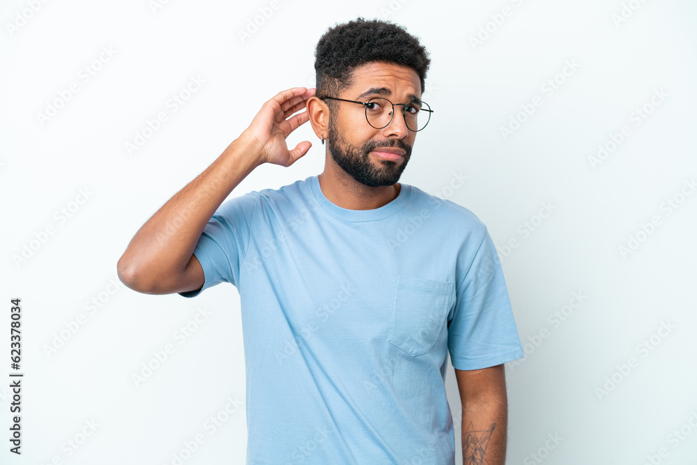 Young Brazilian man isolated on white background having doubts Young Brazilian man isolated on white background having doubts