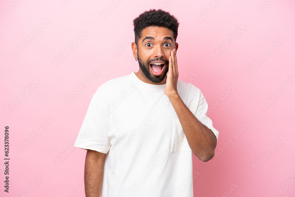 Young Brazilian man isolated on pink background with surprise and shocked facial expression Young Brazilian man isolated on pink background with surprise and shocked facial expression
