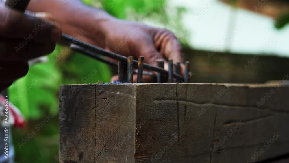 close up of carpenter using manual tools for bending metal in construction site close up of carpenter using manual tools for bending metal in construction site