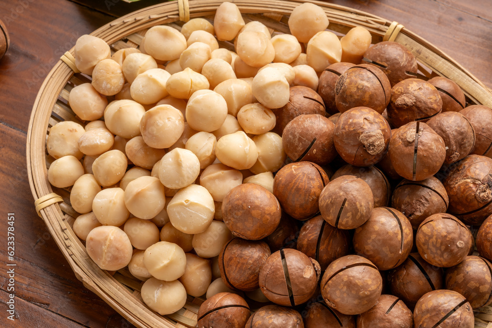 Roasted Macadamia nut in wooden plate on wooden background. Roasted Macadamia nut in wooden plate on wooden background.
