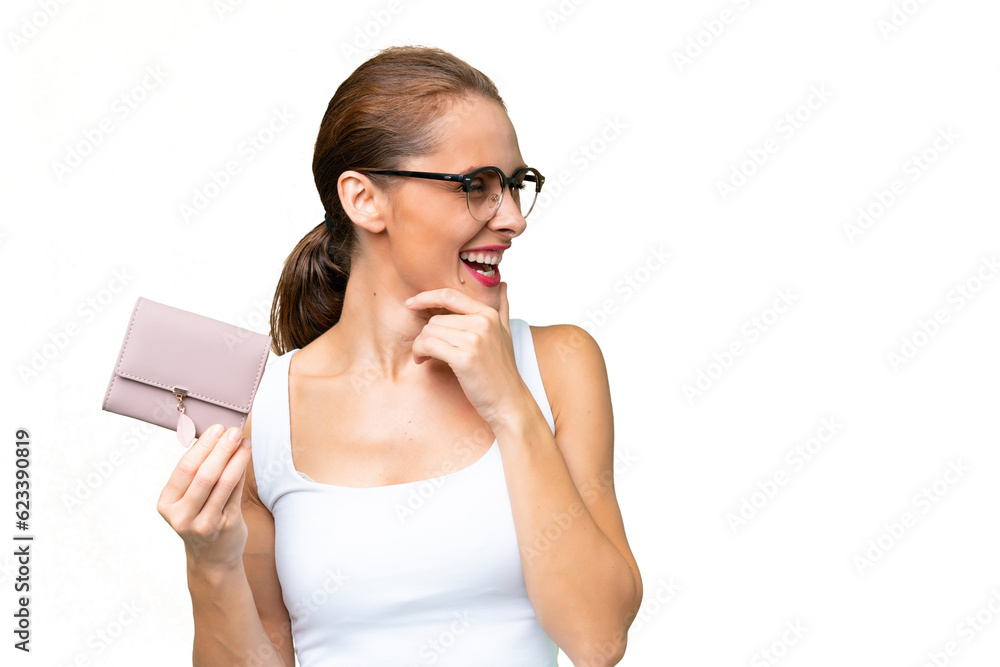 Young caucasian woman holding a wallet over isolated background thinking an idea and looking side Young caucasian woman holding a wallet over isolated background thinking an idea and looking side