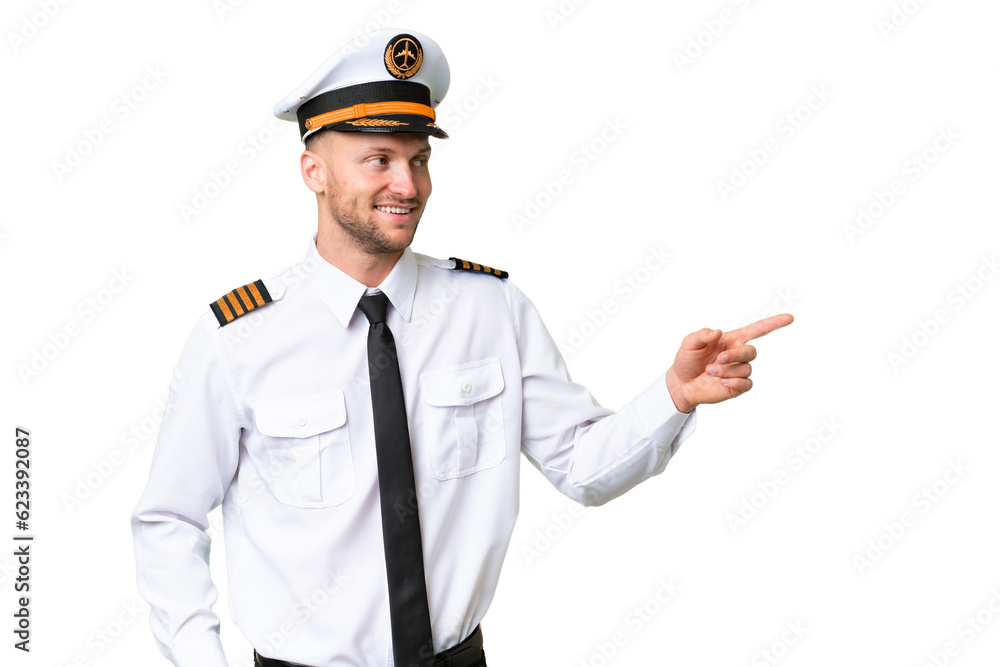 Airplane pilot man over isolated background pointing finger to the side and presenting a product
