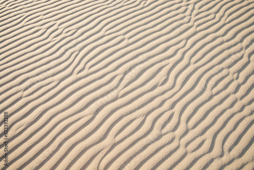 Scenic view on natural ripple sand pattern during sunrise at Mesquite Flat Sand Dunes, Death Valley National Park, California, USA. Morning walk in Mojave desert with Amargosa Mountain Range in back