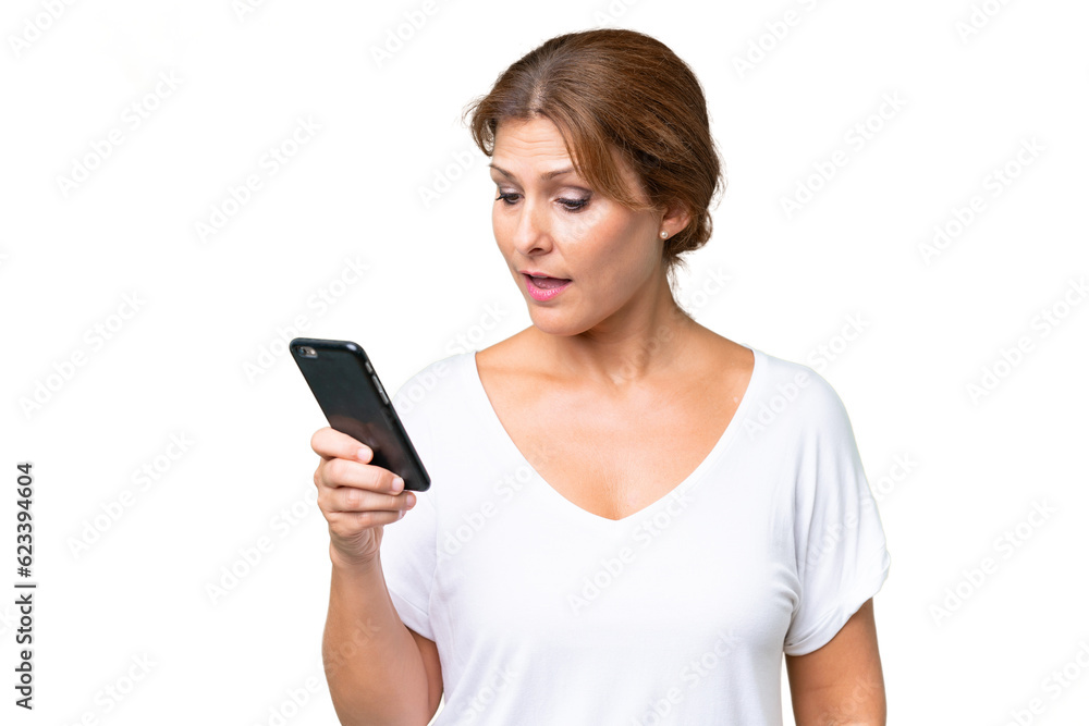 Middle-aged caucasian woman over isolated background sending a message or email with the mobile Middle-aged caucasian woman over isolated background sending a message or email with the mobile