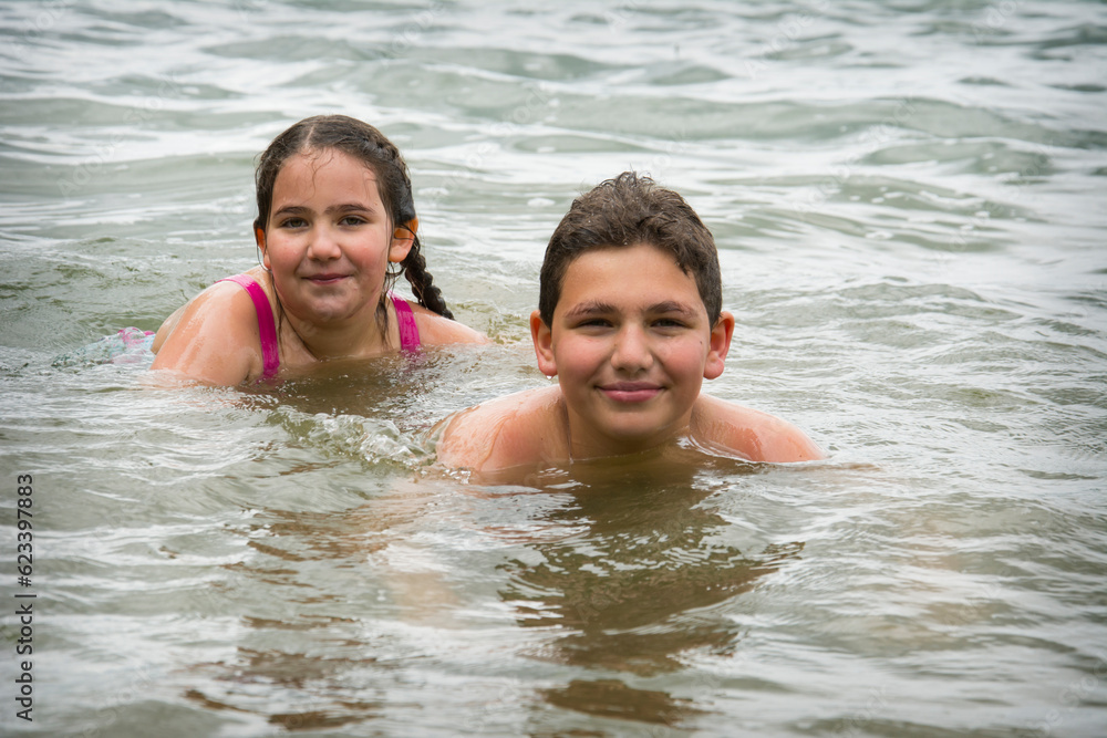 In summer, brother and sister bathe in the river. In summer, brother and sister bathe in the river.