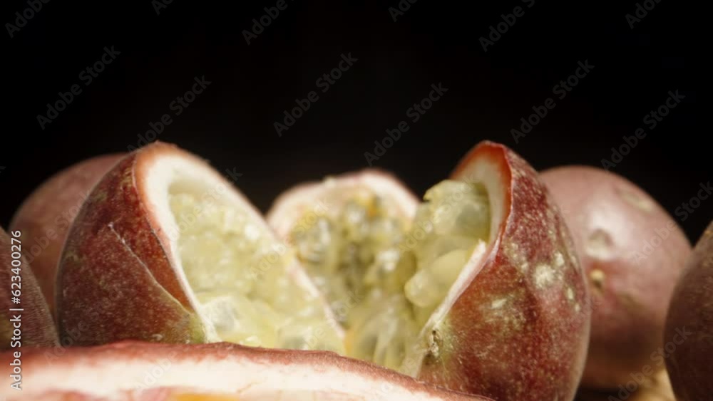 Sliced passion fruits on the table, camera gliding through them. Dolly slider extreme close-up. Sliced passion fruits on the table, camera gliding through them. Dolly slider extreme close-up.