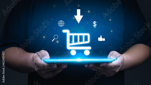 Hand of businessman showing shopping cart icon on tablet, Online shopping and e-commerce concept.