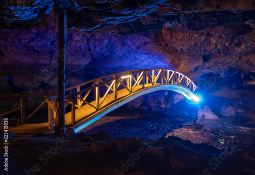 Bridge in Bolii cave ( Pestera Bolii ), near Petrosani city, Hunedoara county, Romania. The cave is artificially illuminated and is open to visitors. photo