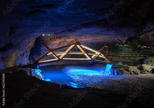 Bridge in Bolii cave ( Pestera Bolii ), near Petrosani city, Hunedoara county, Romania. The cave is artificially illuminated and is open to visitors. photo