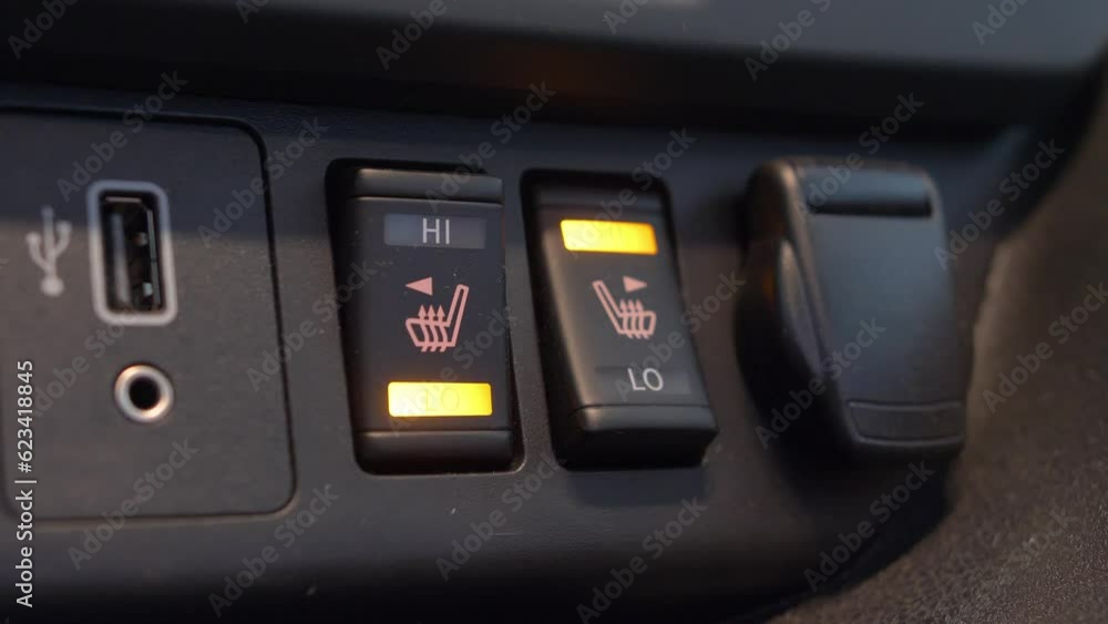 Heated Car Seat Switches Being Toggled to Control Seat Warmers Heated Car Seat Switches Being Toggled to Control Seat Warmers