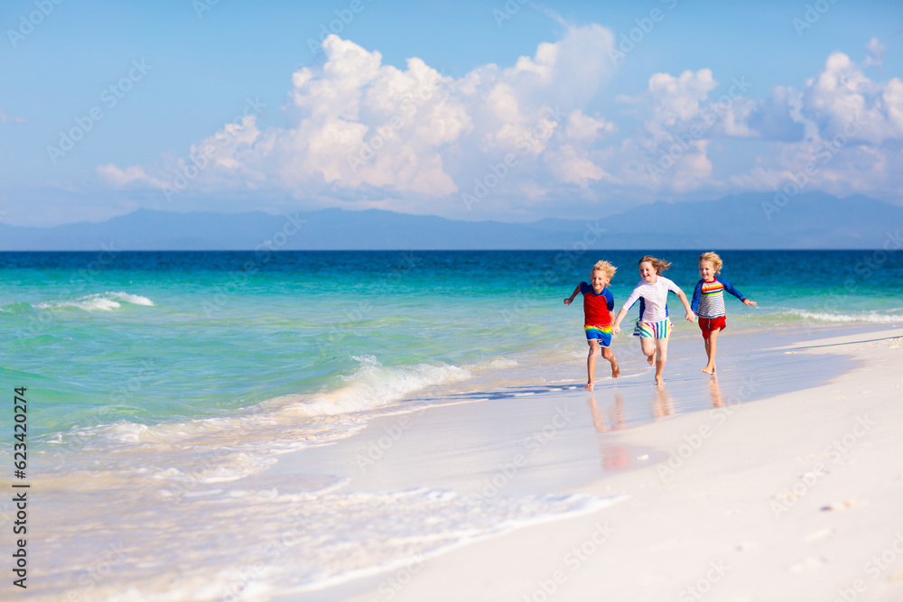 Kids playing on beach. Children play at sea. Kids playing on beach. Children play at sea.