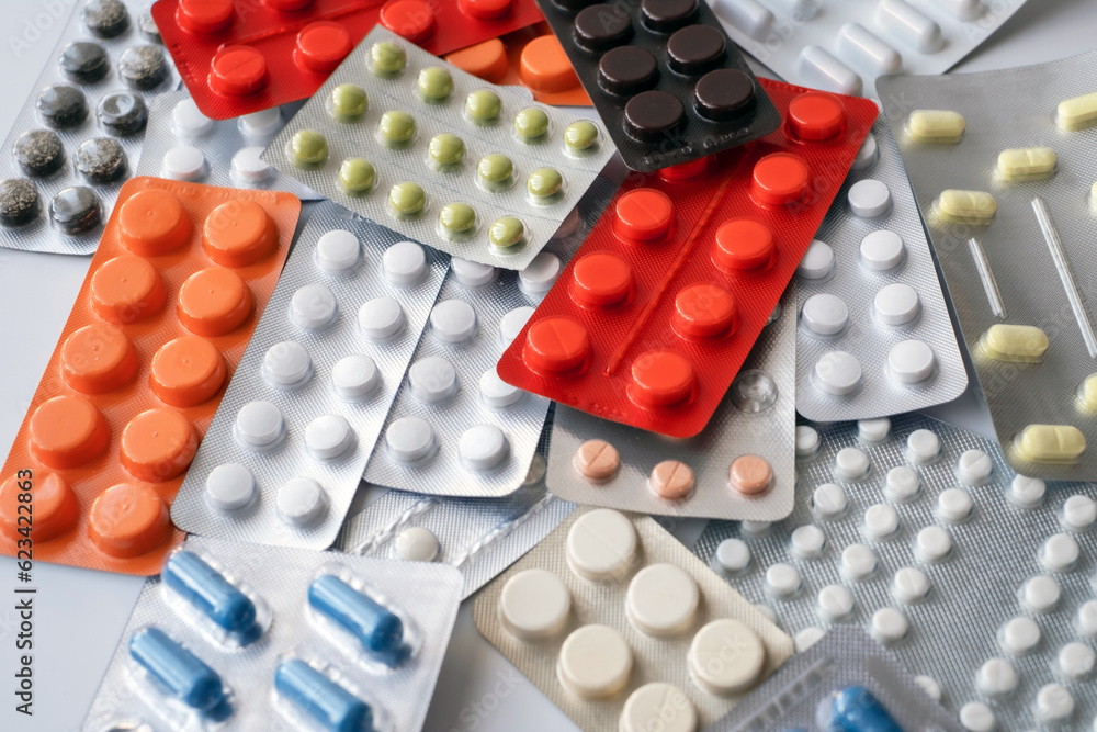 Pills background. Heap of assorted various medicine tablets and pills different colors. Health care. Top view Pills background. Heap of assorted various medicine tablets and pills different colors. Health care. Top view
