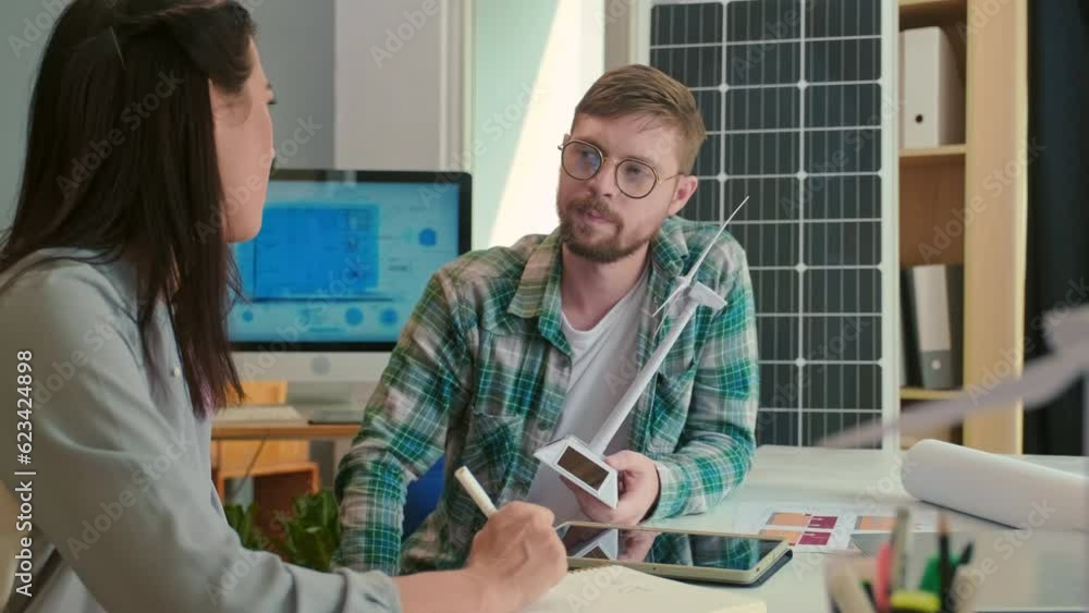 Rack focus of manager and engineer talking about details of wind power project Rack focus of manager and engineer talking about details of wind power project