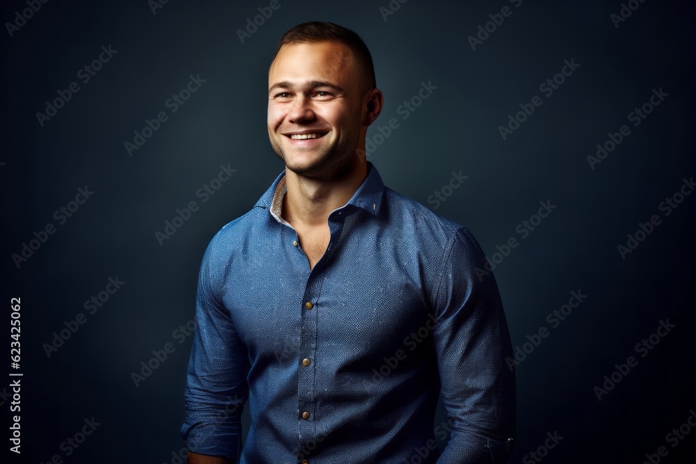 Obraz premium Medium shot portrait photography of a beautiful boy in his 30s wearing a classy button-up shirt against a navy blue background. With generative AI technology