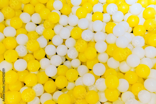 White and yellow plastic balls for children's dry pool.