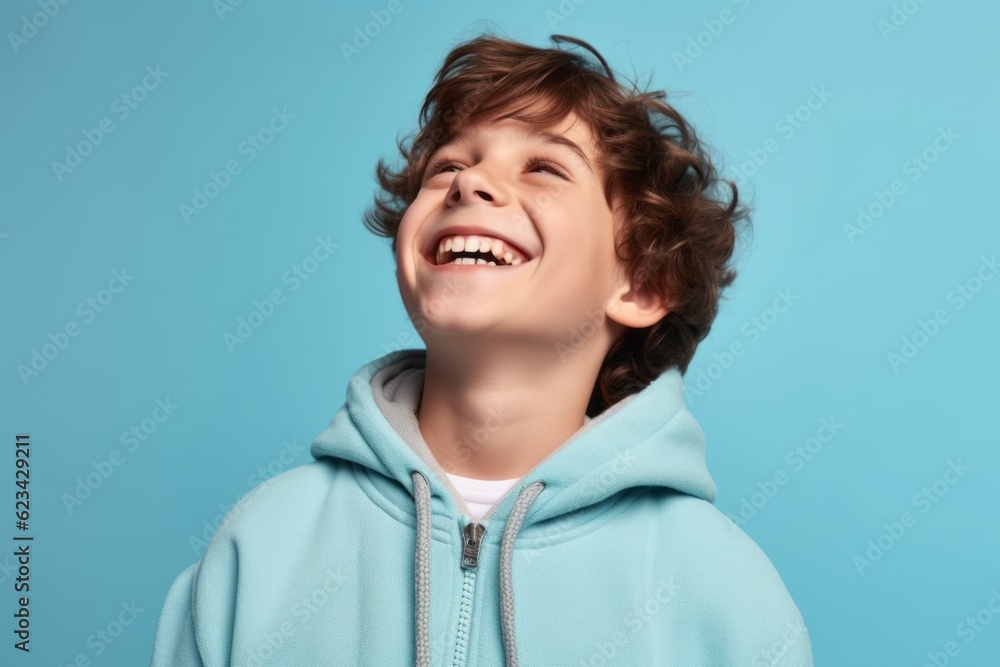 Close-up portrait photography of a joyful boy in his 30s wearing a comfortable tracksuit against a soft blue background. With generative AI technology Close-up portrait photography of a joyful boy in his 30s wearing a comfortable tracksuit against a soft blue background. With generative AI technology