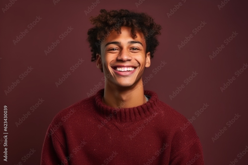 Medium shot portrait photography of a satisfied boy in his 20s wearing a cozy sweater against a rich maroon background. With generative AI technology