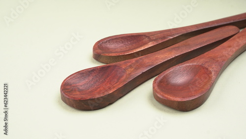 Empty wooden bowl and wooden spoon isolated with copy space.