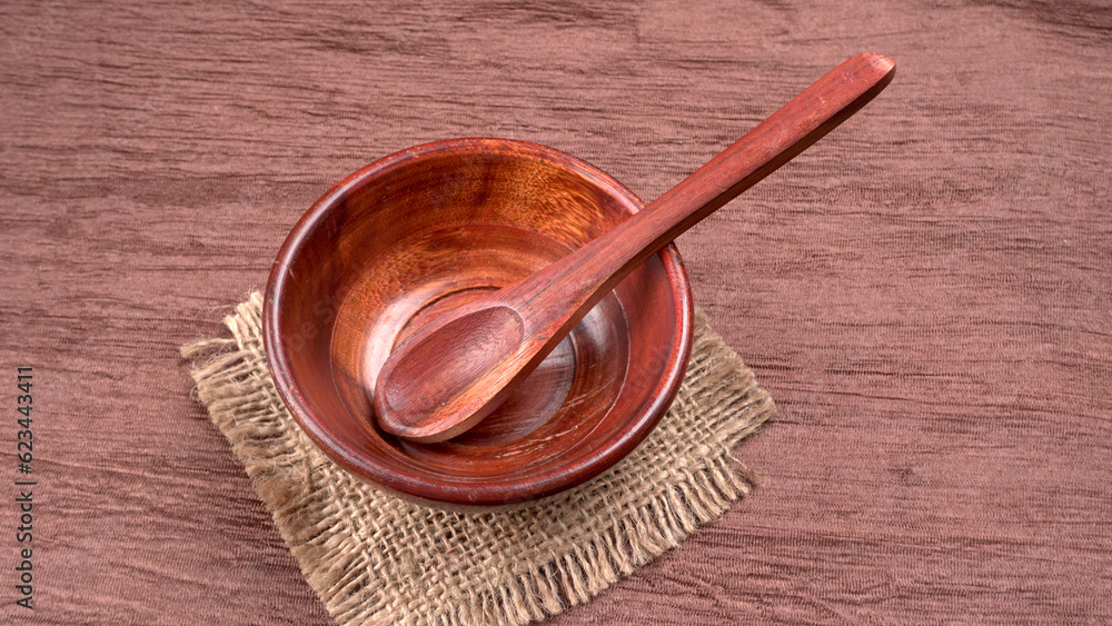Empty wooden bowl and wooden spoon isolated with copy space. Empty wooden bowl and wooden spoon isolated with copy space.