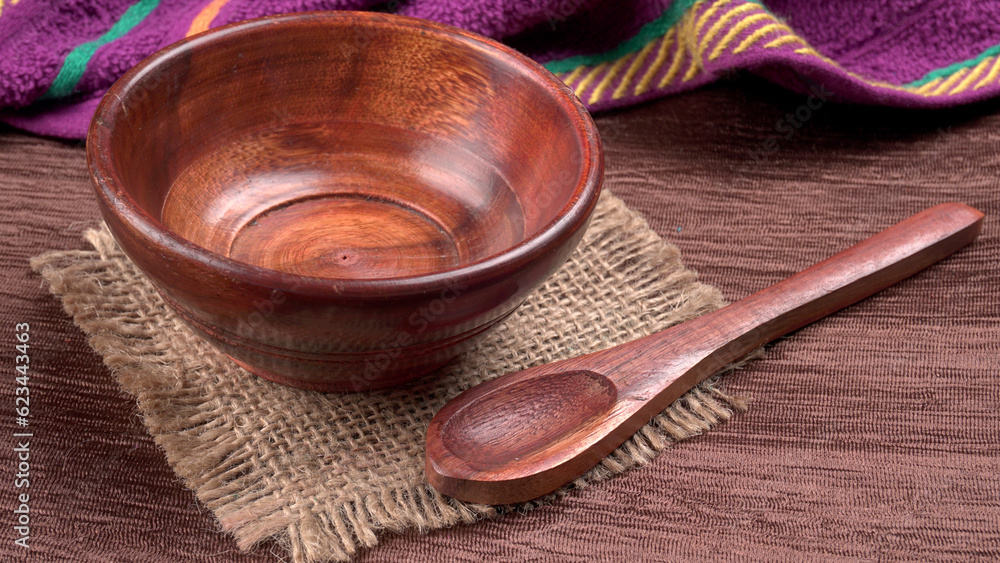 Empty wooden bowl and wooden spoon isolated with copy space. Empty wooden bowl and wooden spoon isolated with copy space.