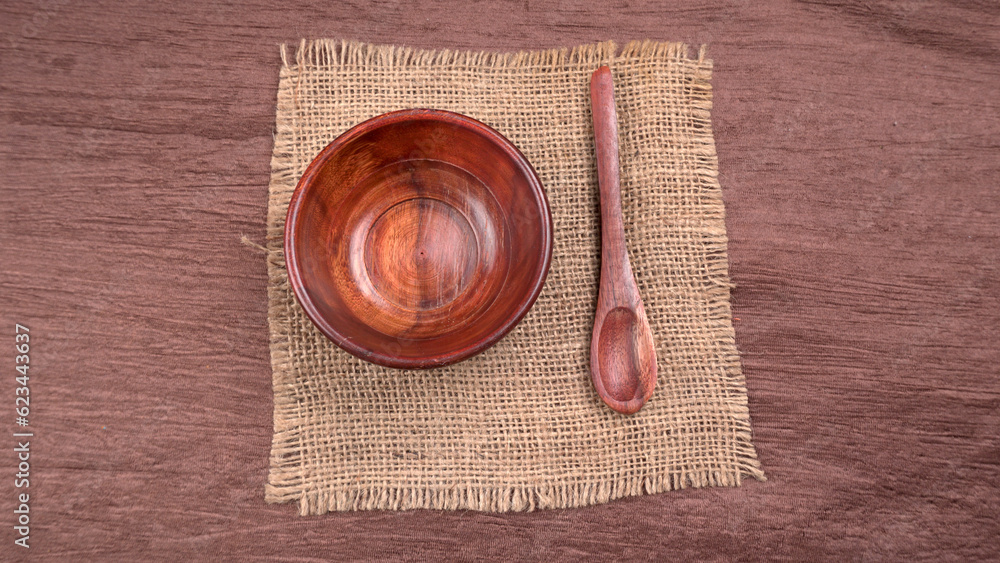 Empty wooden bowl and wooden spoon isolated with copy space. Empty wooden bowl and wooden spoon isolated with copy space.