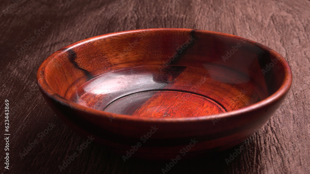 Empty wooden bowl and wooden spoon isolated with copy space. Empty wooden bowl and wooden spoon isolated with copy space.