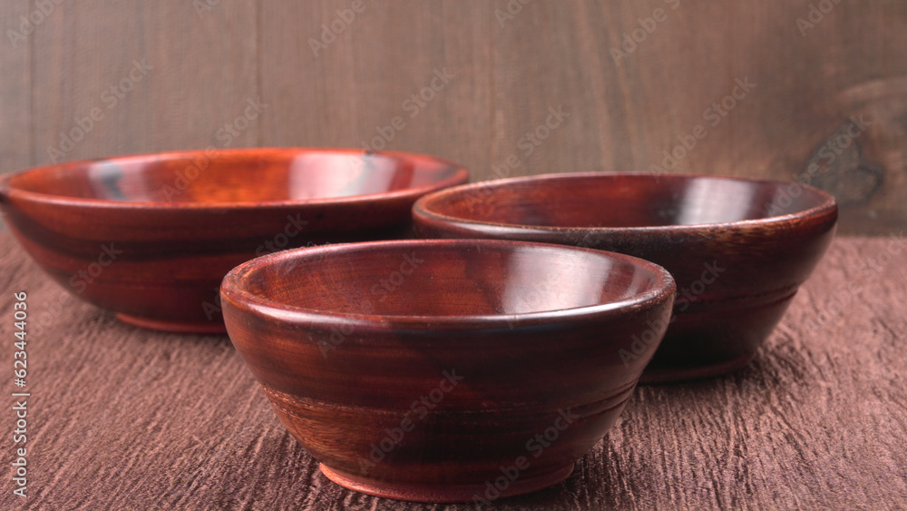 Empty wooden bowl and wooden spoon isolated with copy space. Empty wooden bowl and wooden spoon isolated with copy space.
