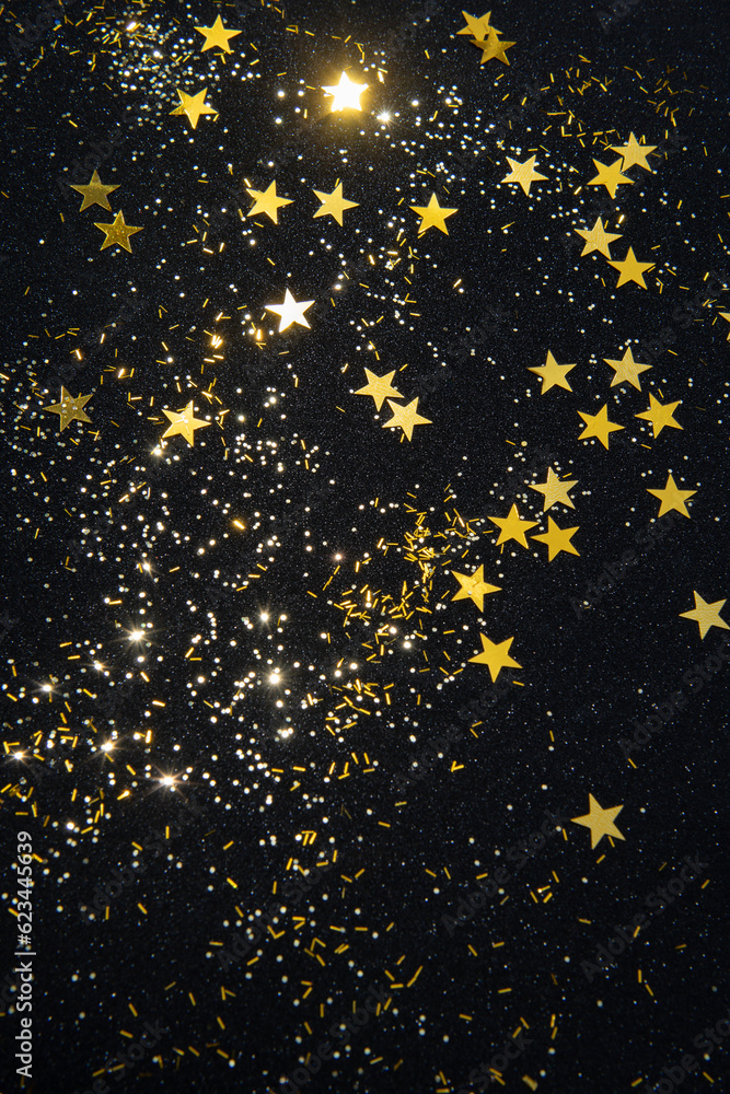 gold star confetti and glitter on a black glitter background Stock ...