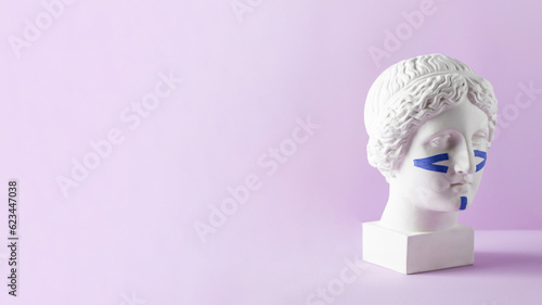 Photos Blue tapes for the face on the bust on a purple background