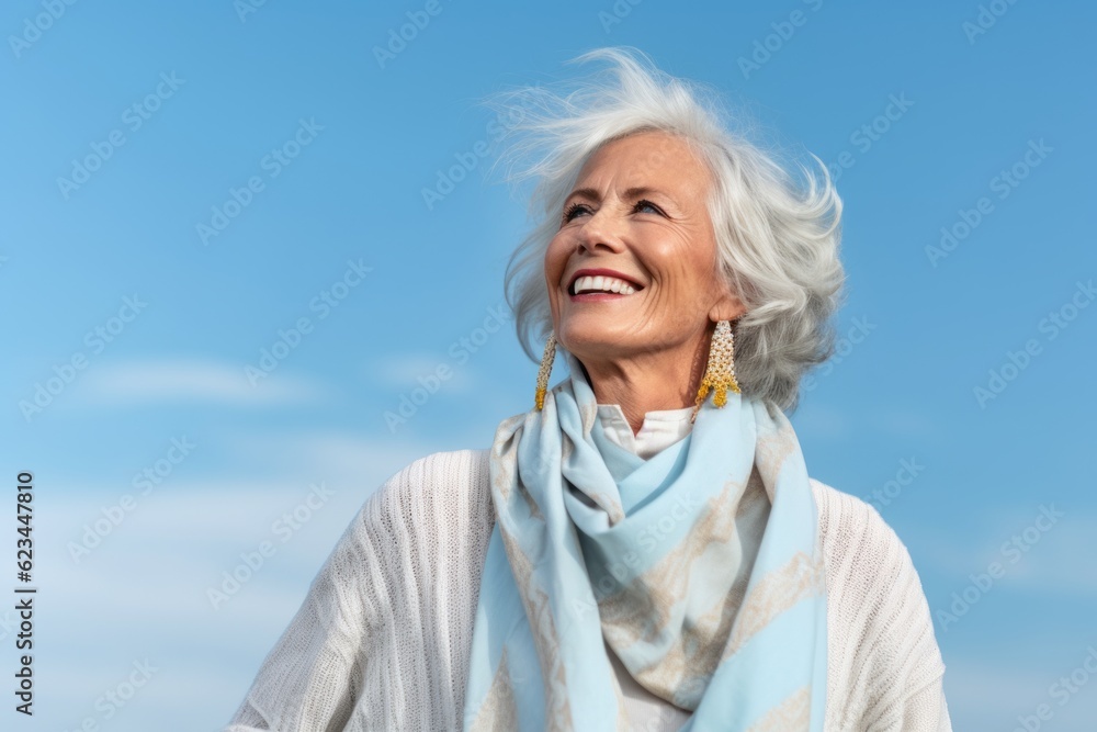 Lifestyle portrait photography of a glad old woman wearing a chic cardigan against a sky-blue background. With generative AI technology Lifestyle portrait photography of a glad old woman wearing a chic cardigan against a sky-blue background. With generative AI technology