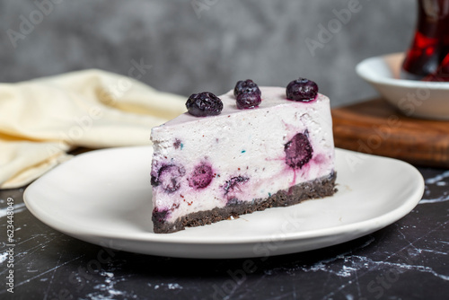 Blueberry cake. Blueberry fruit slice cake on dark background. Close up