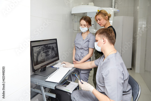 A team of young dentists works in a well-equipped office.