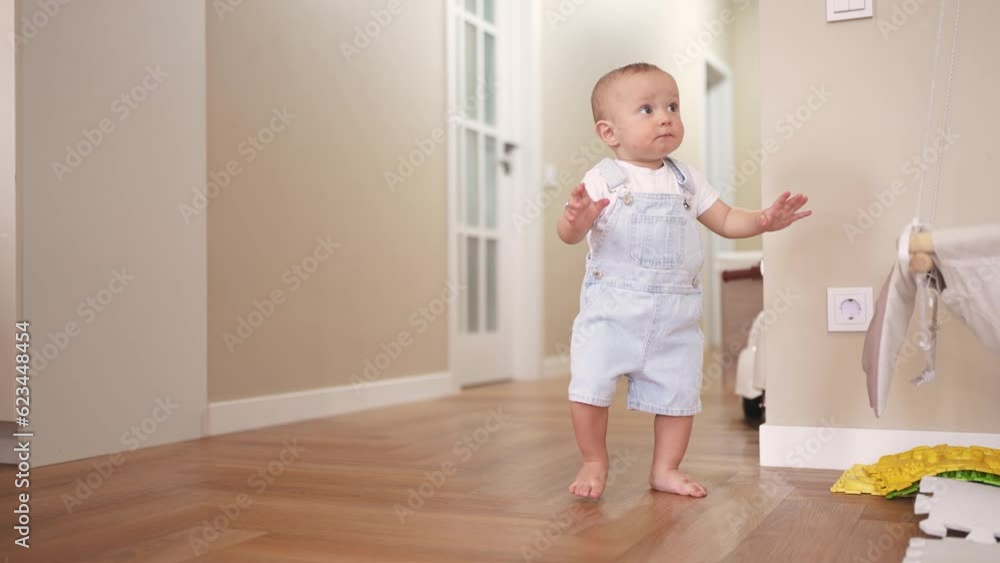 baby first steps. son a baby toddler learning to walk take first steps. happy family kid dream concept. baby indoors learning to walk indoors. lifestyle baby son training concept baby first steps. son a baby toddler learning to walk take first steps. happy family kid dream concept. baby indoors learning to walk indoors. lifestyle baby son training concept