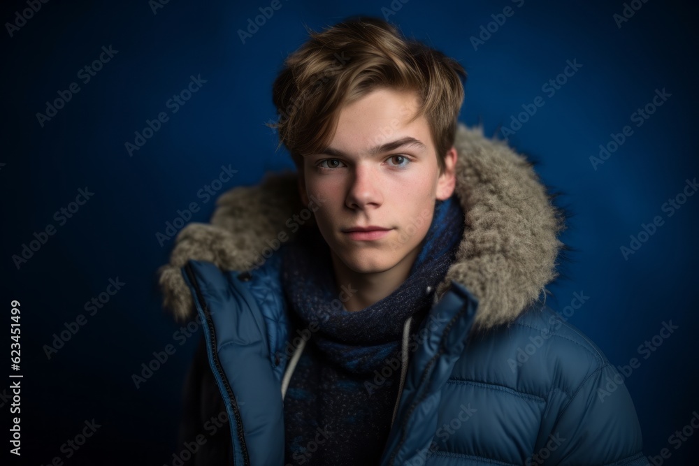 Group portrait photography of a beautiful boy in his 20s wearing a cozy winter coat against a sapphire blue background. With generative AI technology Group portrait photography of a beautiful boy in his 20s wearing a cozy winter coat against a sapphire blue background. With generative AI technology