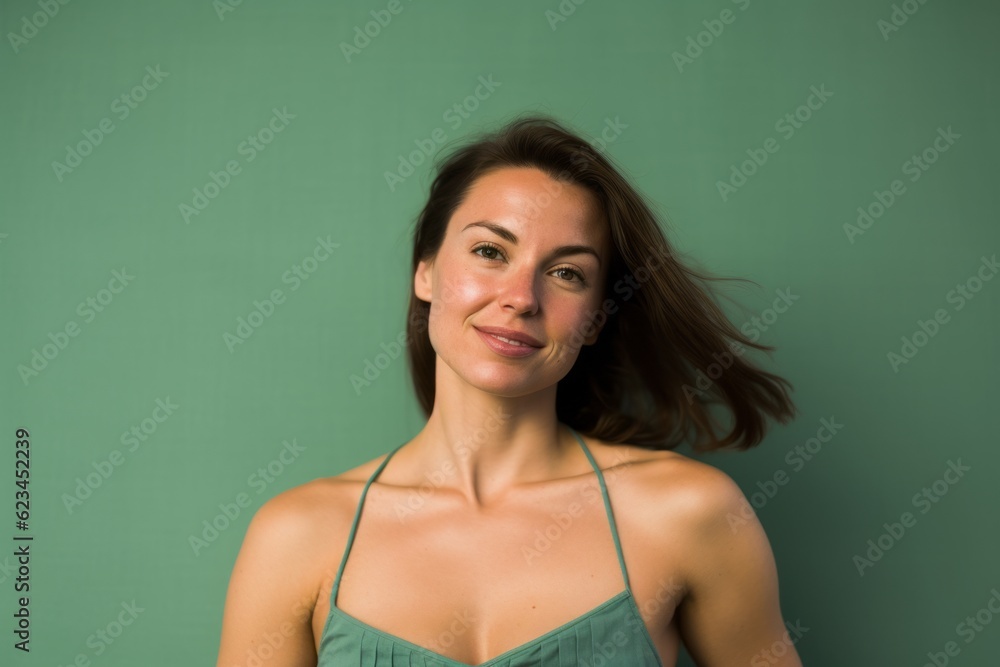 Lifestyle portrait photography of a glad girl in her 30s wearing a daring tube top against a spearmint green background. With generative AI technology Lifestyle portrait photography of a glad girl in her 30s wearing a daring tube top against a spearmint green background. With generative AI technology