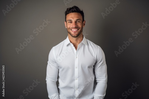 Headshot portrait photography of a happy boy in his 30s wearing an elegant long-sleeve shirt against a minimalist or empty room background. With generative AI technology
