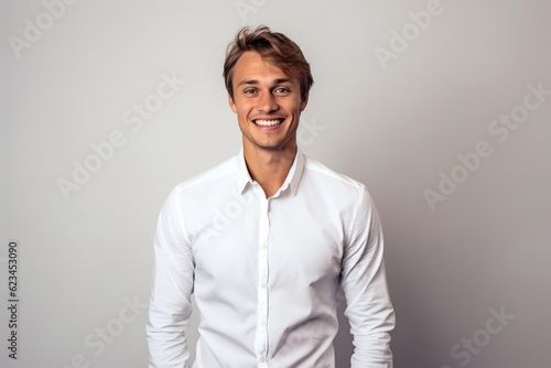Medium shot portrait photography of a grinning boy in his 30s wearing a classy button-up shirt against a minimalist or empty room background. With generative AI technology © Markus Schröder