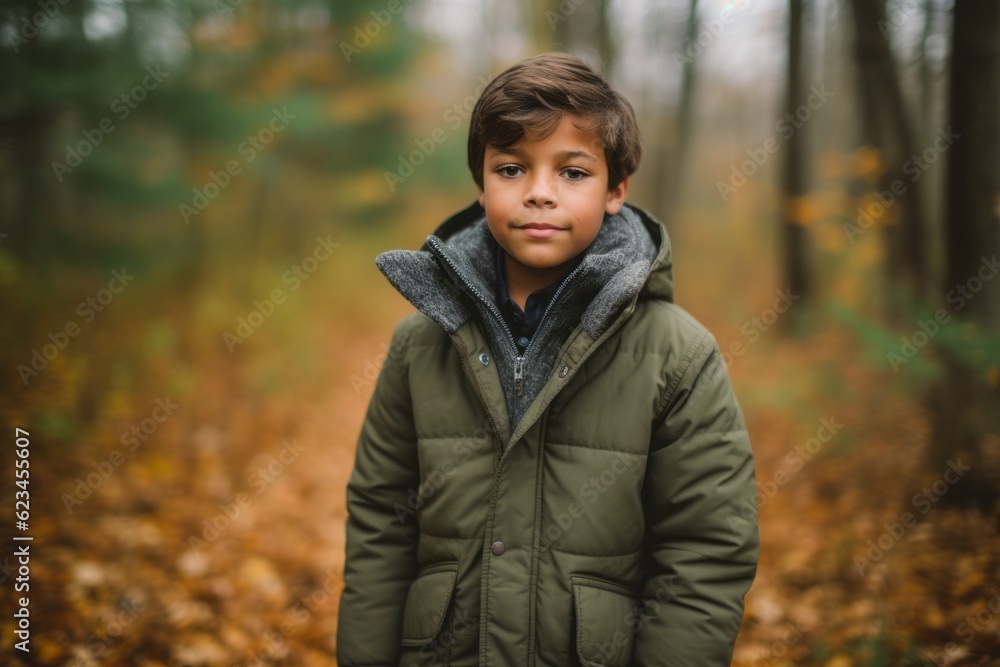 Editorial portrait photography of a glad kid male wearing a cozy winter coat against a forest background. With generative AI technology Editorial portrait photography of a glad kid male wearing a cozy winter coat against a forest background. With generative AI technology