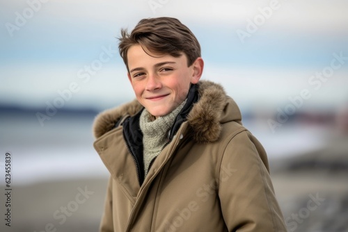 Three-quarter studio portrait photography of a glad boy in his 30s wearing a cozy winter coat against a beach background. With generative AI technology