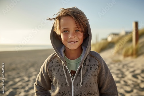 Eclectic portrait photography of a happy boy in his 30s wearing a cozy zip-up hoodie against a beach background. With generative AI technology © Markus Schröder
