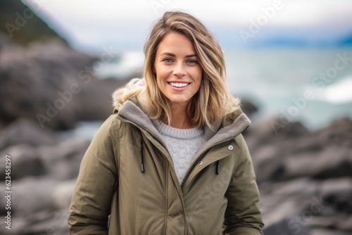 Sports portrait photography of a happy girl in her 30s wearing a cozy winter coat against a tropical island background. With generative AI technology © Markus Schröder