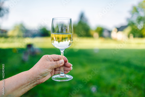 Female hand with glass of r wine. Cozy hotel on the coast of Lagos. Sea view, beautiful landscape in Portugal Adventure in Europe. High quality photo