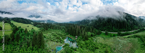 Fototapeta Naklejka Na Ścianę i Meble -  Zelenci Nature Reserve in Slovenia. Mountain wetlands with spring-fed turquoise lake , rare plants & wading birds. Aerial drone view.