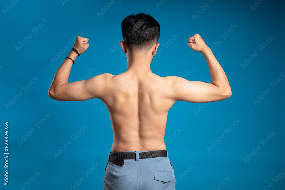 Muscular young man showing off his determined body