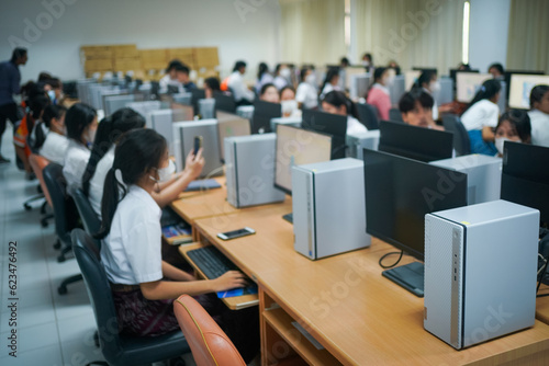 Blur and selective focus of the university student using computer studying in the computer room