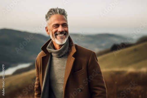 Lifestyle portrait photography of a tender mature man wearing a cozy winter coat against a rolling hills background. With generative AI technology